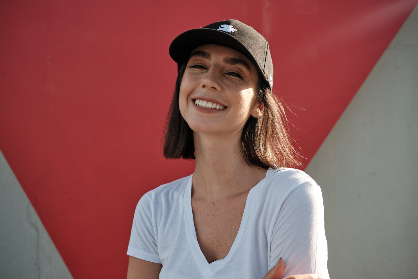 Flying Ghost Space Black Baseball Hat - MOOD Caps model smiley red background