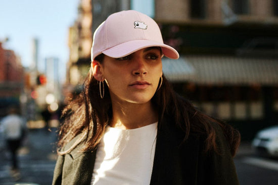 MOOD Caps model wearing signature flying ghost hat in cotton candy pink in NYC