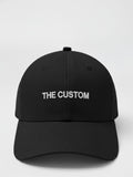 Black cap with 'THE CUSTOM' text on a white background