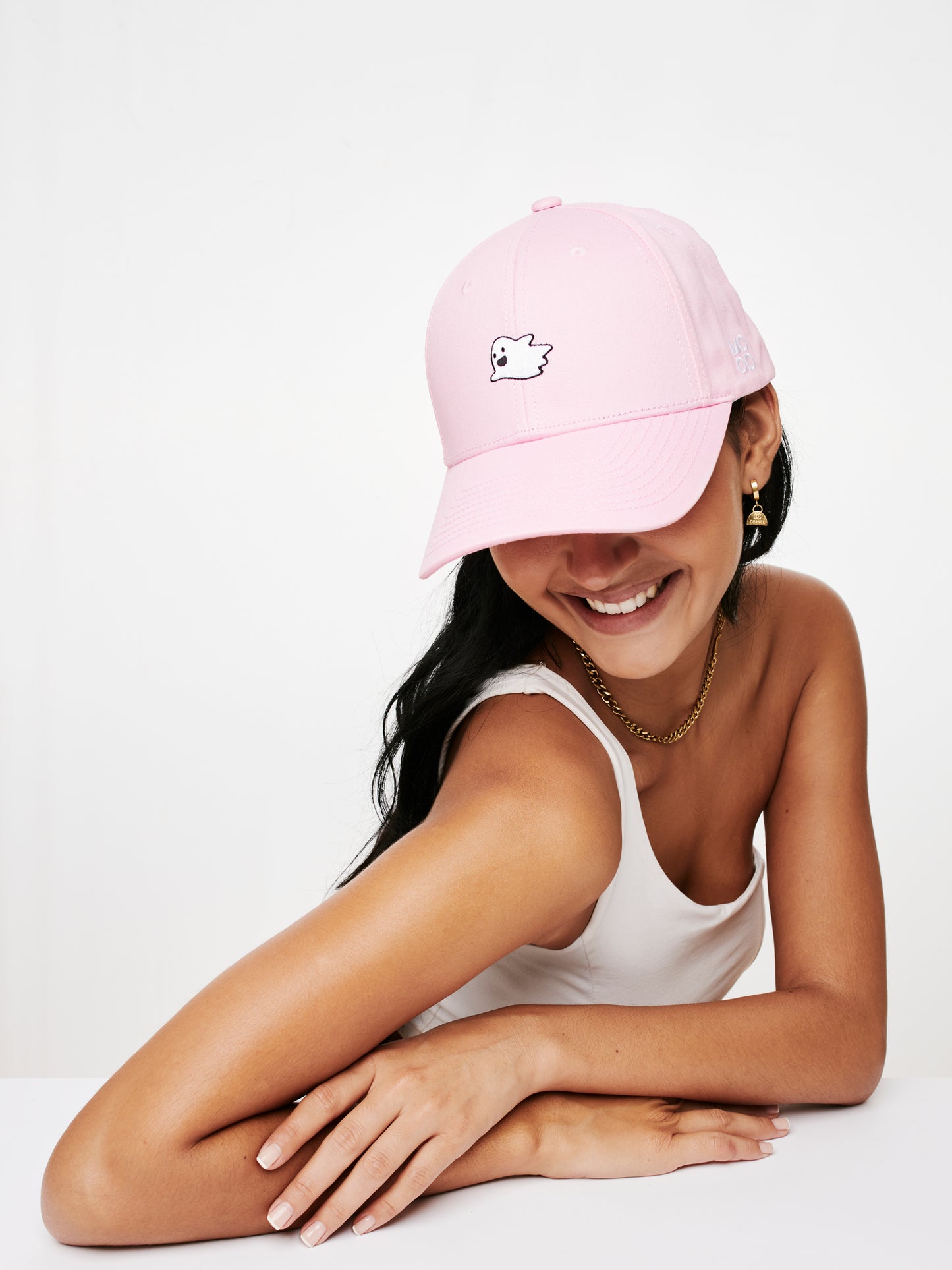 MOOD female model wearing Flying Ghost baseball cap in pink color smiling